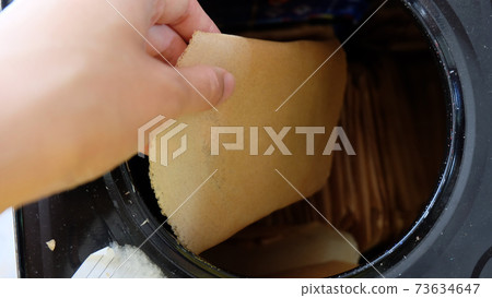 Hand taking out a piece of kuih kapit, an egg wafer snack popular in Indonesia, Malaysia, Brunei and Singapore. Hand taking out a piece of kuih kapit, an egg wafer snack popular in Indonesia, Malaysia, Brunei and Singapore. 73634647