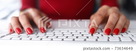 Girl in red clothes click on the keyboard close-up 73634649