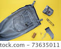 Remake of old vintage jeans. Sewing a style sundress from husband's retro jeans. Yellow background. Stock image. Reuse concept. Top view 73635011
