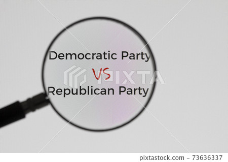 Inscription Democratic Party VS Republican Party on display screen through magnifying glass. Illustrative Editorial. Concept of news 73636337