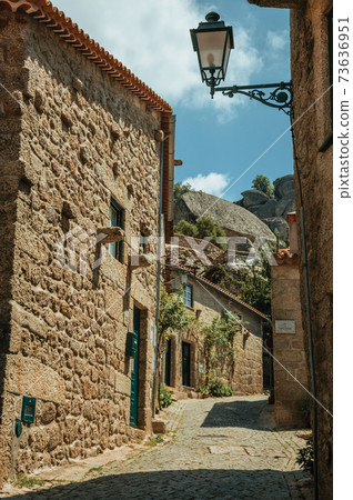 Old stone houses in alley on slope in Monsanto Old stone houses in alley on slope in Monsanto 73636951