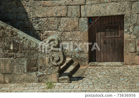 Stone baluster with carved decoration and door 73636956