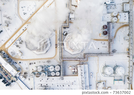 Thermal power plant in winter in the city of Minsk. Smoke is coming from the big Chimneys Thermal power plant in winter in the city of Minsk. Smoke is coming from the big Chimneys 73637002