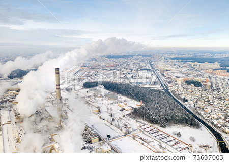 Thermal power plant in winter in the city of Minsk. Smoke is coming from the big Chimneys Thermal power plant in winter in the city of Minsk. Smoke is coming from the big Chimneys 73637003