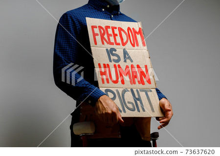 Freedom is a human right placard in hands of protester Freedom is a human right placard in hands of protester 73637620