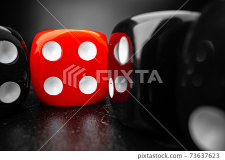 Group of playing dice cubes on black surface, macro Group of playing dice cubes on black surface, macro 73637623
