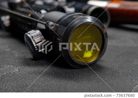 Optical sight of hunting rifle on grey background 73637680