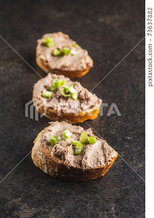Liver pate on sliced baguette. Liver pate on sliced baguette. 73637882
