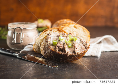 Liver pate on sliced baguette. Liver pate on sliced baguette. 73637883