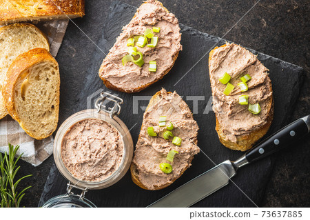 Liver pate on sliced baguette. Liver pate on sliced baguette. 73637885