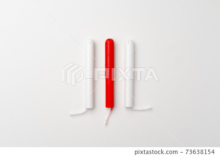 Red and white woman medical tampons on white background 73638154