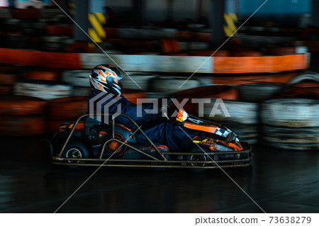 Dynamic karting competition at speed with blurry motion on an equipped racecourse 73638279