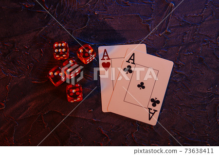 Online gambling сoncept. Aces and five red dices on a grey background Online gambling сoncept. Aces and five red dices on a grey background 73638411