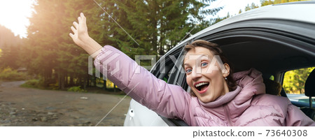 Portrait of young adult beautiful caucasian woman driver enjoy roadtrip adventure traveling by car on mountain nature forest landscape. Happy female person family journey trip lifestyle 73640308