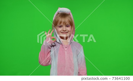 Little child girl smiling, showing ok gesture, agree sign in unicorn pajama on chroma key background Little child girl smiling, showing ok gesture, agree sign in unicorn pajama on chroma key background 73641100