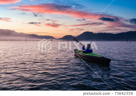 Adventurous Girl kayaking on an infatable kayak Adventurous Girl kayaking on an infatable kayak 73642359