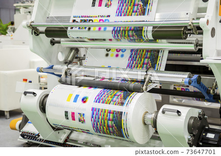 Large offset printing press or magazine running a long roll off paper in production line of industrial printer machine. 73647701