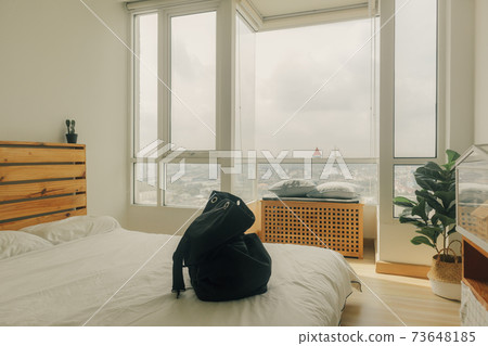 Preparing a black backpack for a trip. 73648185