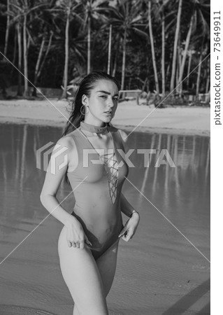 women on the beach in the tropics, in the Philippines 73649911
