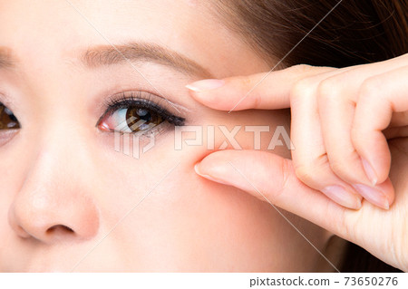 Wrinkles on the corners of the eyes. 73650276
