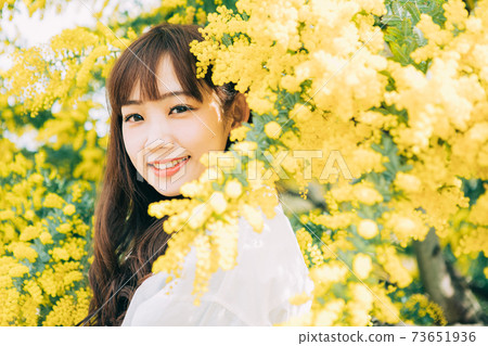 Mimosa and young woman 73651936