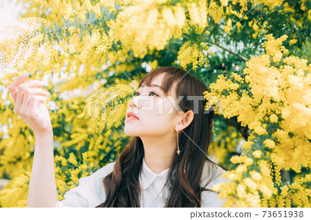 Mimosa and young woman 73651938