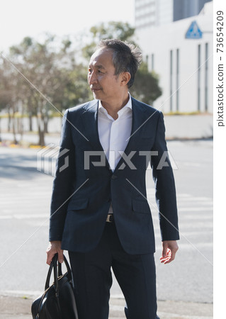 日本男人和中年商人穿著六十年代西裝的形象 73654209