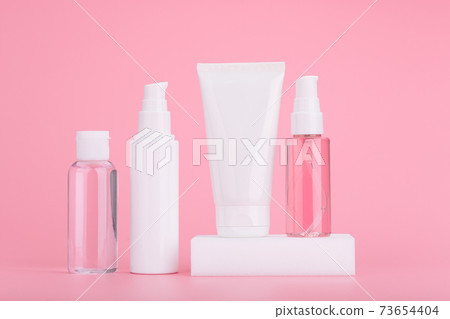 Set of skincare cosmetics against bright pink background. Concept of daily skincare routine and beauty products Set of skincare cosmetics against bright pink background. Concept of daily skincare routine and beauty products 73654404
