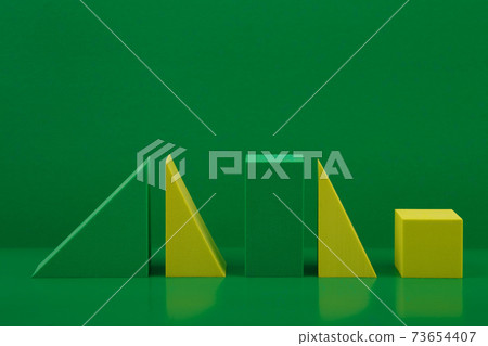 Green and yellow geometric figures against green background. Abstract monochromatic concept with space for text Green and yellow geometric figures against green background. Abstract monochromatic concept with space for text 73654407