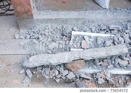 Leftover broken cement on concrete floor . Home improvement concept 73654572