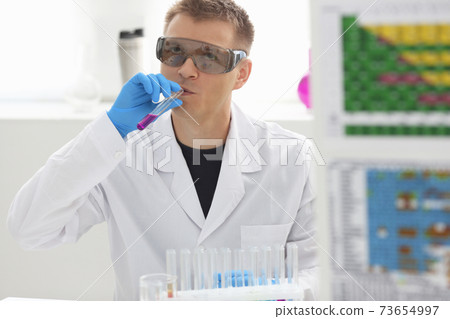 Employee of chemical laboratory teacher chemist tries homemade alcohol 73654997