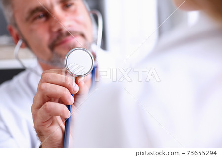Male doctor hold in arm stethoscope head 73655294