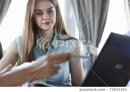 Two business women communicate in a cafe Two business women communicate in a cafe 73655301