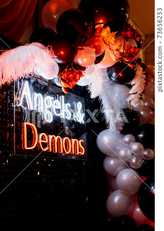 a photo zone themed angels and demons in black with white and black balls 73656253