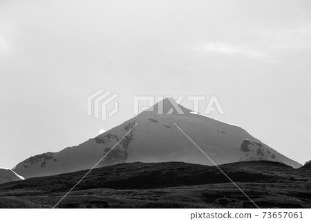Silhouette of high snowy mountains with glacier, rocks at early morning 73657061