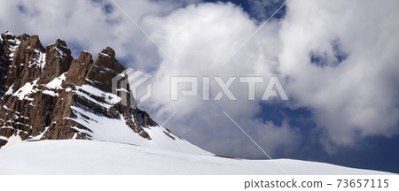 Rock and snow pass in clouds 73657115
