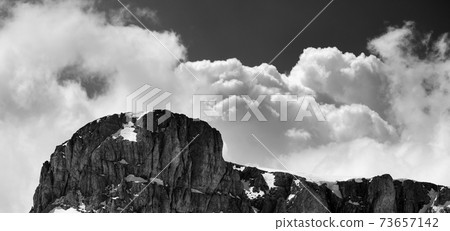Top of mountain with snow and sky with clouds Top of mountain with snow and sky with clouds 73657142
