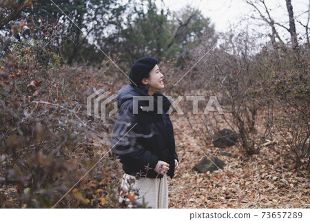 Woman walking in the park Woman walking in the park 73657289