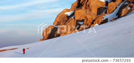 Hiker at sunrise mountains Hiker at sunrise mountains 73657293