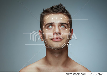 Beautiful male face with lifting up arrows isolated on grey background 73657626