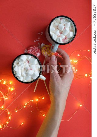 Valentine hot chocolate or coffee, Two red cups with hot chocolate or latte drink, with whipped cream ans sugar heart sprinkles 73658817