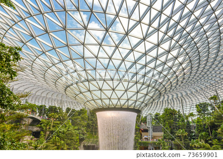 SINGAPORE - December 22, 2019: The largest indoor waterfall inside Jewel Changi Airport in Singapore SINGAPORE - December 22, 2019: The largest indoor waterfall inside Jewel Changi Airport in Singapore 73659901