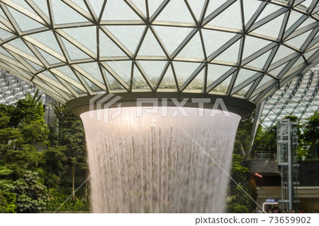 SINGAPORE - December 22, 2019: The largest indoor waterfall inside Jewel Changi Airport in Singapore SINGAPORE - December 22, 2019: The largest indoor waterfall inside Jewel Changi Airport in Singapore 73659902