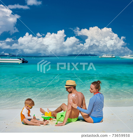 Family with three year old boy on beach Family with three year old boy on beach 73659938