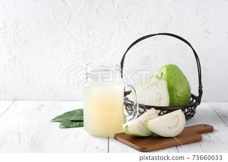 Guava juice guava wood background beverage fruit cold drink drink dieting glass fresh fruit milkshake healthy fresh tropical Guava juice guava wood background beverage fruit cold drink drink dieting glass fresh fruit milkshake healthy fresh tropical 73660033