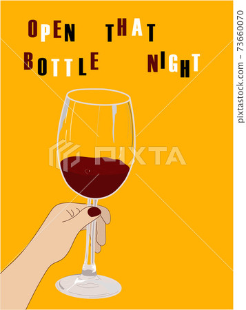 Hand holding wine glass on the yellow background. 73660070