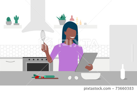A young black woman looks on tablet and cooking by online video tutorial in her kitchen. Online culinary school. Online courses, e-learning. Eps 10 A young black woman looks on tablet and cooking by online video tutorial in her kitchen. Online culinary school. Online courses, e-learning. Eps 10 73660383