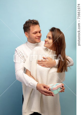 Beautiful couple in love on blue studio background. Valentine's Day, love and emotions concept Beautiful couple in love on blue studio background. Valentine's Day, love and emotions concept 73661974