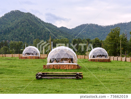 White round houses with transparent walls in a mountain valley White round houses with transparent walls in a mountain valley 73662019