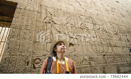 Asian tourist woman photo with Temple of Edfu interior Egypt Horus god landmark 73662444